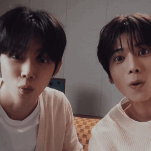Two Young Men Making Funny Faces One in White Shirt