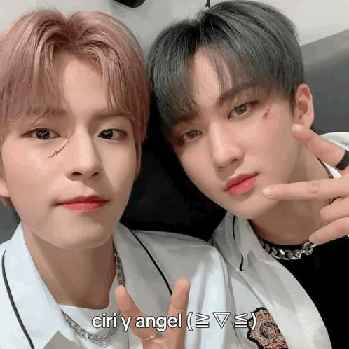 Two Young Men Posing For A Picture With The Words Ciri Y Angel Below Them GIF
