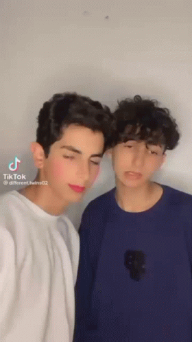 Two Young Men Posing for Picture With TikTok Watermark