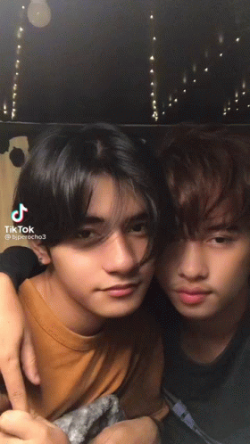 Two Young Men Posing With TikTok Text