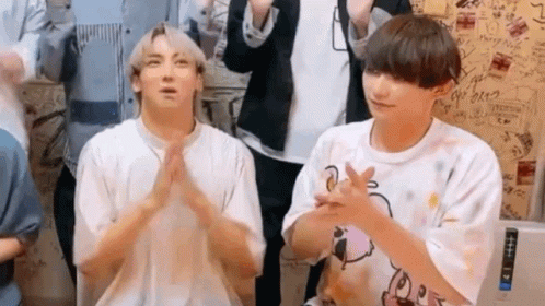 Two Young Men Sitting and Clapping