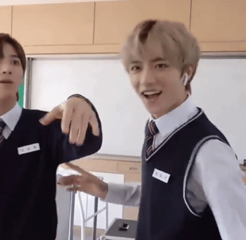 Two Young Men Standing in Classroom One in Vest and Tie
