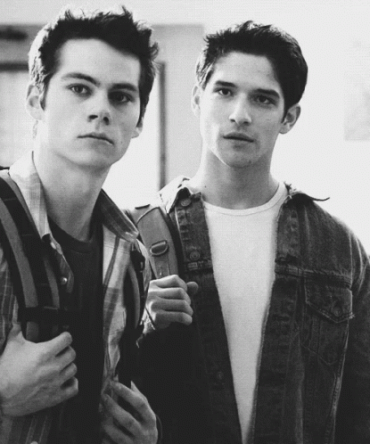 Two Young Men Standing Next to Each Other One With Backpack