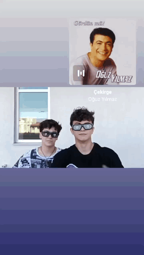 Two Young Men Wearing Sunglasses Are Standing Next To Each Other In Front Of A Window With A Picture Of Oguzyilmaz In Th GIF