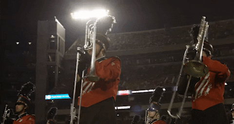 Uga Marching Band Members Lifting Herald Trumpets GIF