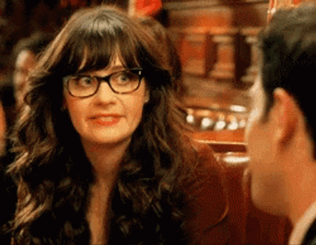 Uncomfortable Smile Of Zooey Deschanel GIF
