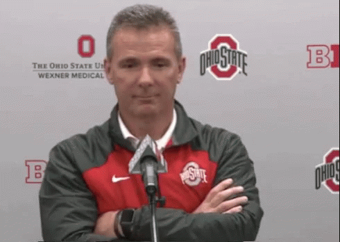 Urban Meyer Holding Phone While Walking Away GIF