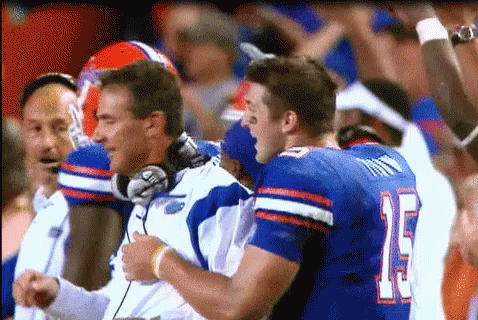 Urban Meyer Smiling While Hugging GIF