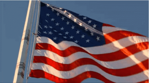 Usa Flag Waving Against Blue Sky GIF