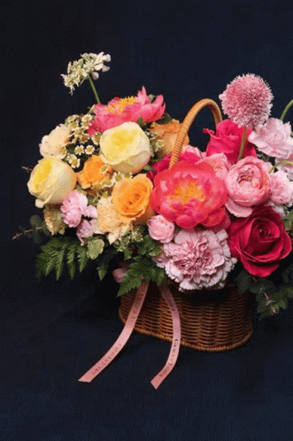 Vase With Yellow and Blue Flowers Against Dark Blue Background