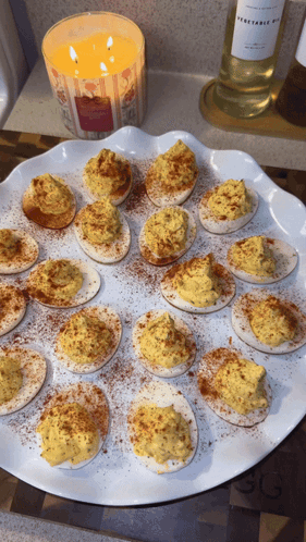Vegetable Oil Candle Next to Stuffed Eggs