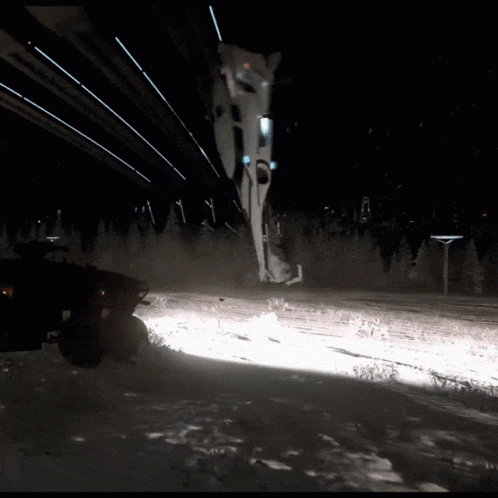 Vehicle Driving Through Snow at Night