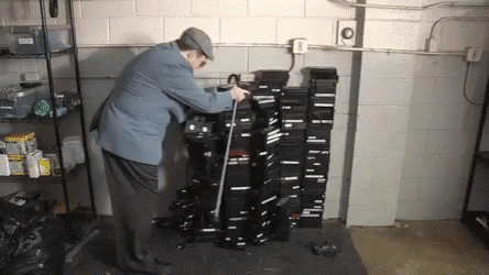 Funny Man Falling On Stack Of Vhs GIF