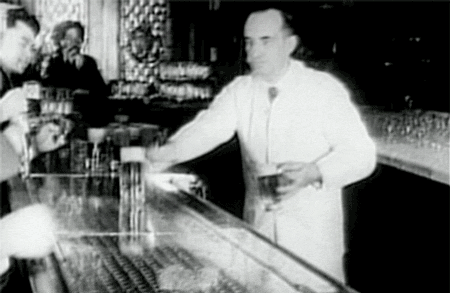 Vintage Bartender Offering Drinks GIF