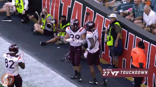 Virginia Tech Football Player Hugged by Two Teammates