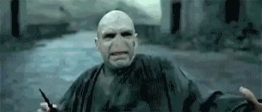 Voldemort From Harry Potter Is Holding A Wand In His Hand And Looking At The Camera . GIF