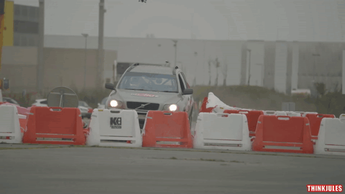 Volvo Car With Del Arte Driving Down a Road