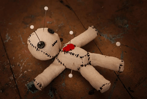 Voodoo Doll With Pins And Heart On Chest GIF