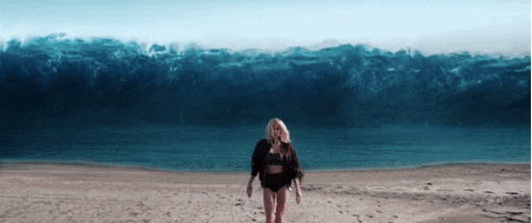 Billie Eilish Walking In Big Waves Background GIF