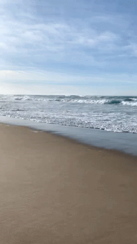 Waves Crashing on Beach Blue Sky