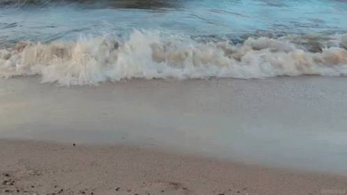 Waves Crashing on Sandy Beach With London Ireland