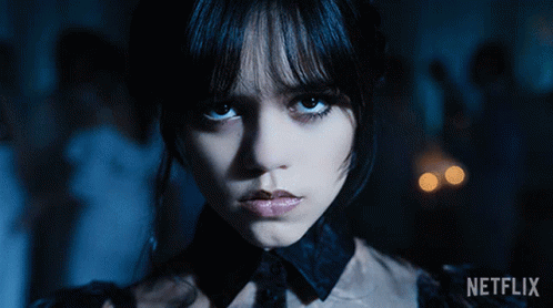 Wednesday Piercing Eyes Twisted Arms Dancing GIF