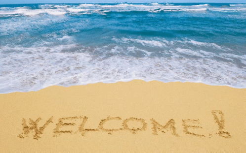 Welcome Written in Sand on Beach