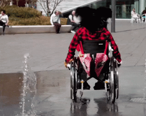Mascot Dog Riding Wheelchair GIF