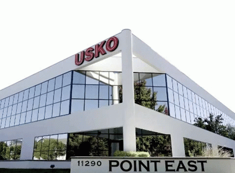 White Building with Point East Sign