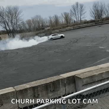 White Car Drifting with Smoke Church Parking Lot Cam