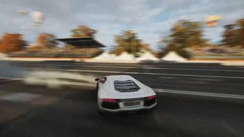White Car Driving Down Road With Smoke
