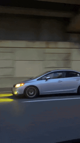 White Car Driving On Highway With Headlights On GIF