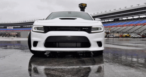 White Car Parked in Wet Parking Lot