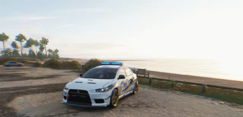 White Car With Blue Light on Dirt Road