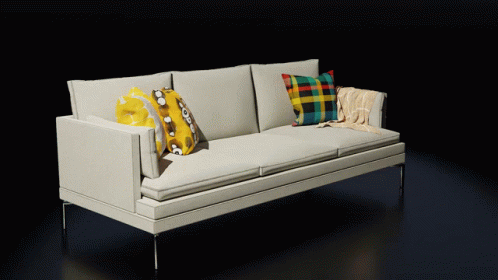 White Couch With Pillows and Blanket