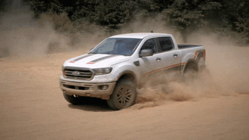 White Ford Truck Driving Through Sandy Area GIF