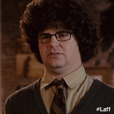 White Guy Wearing Afro Hair Smirks GIF