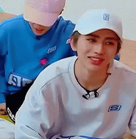 White Hat and Sweatshirt Man Beside Blue Shirt Man
