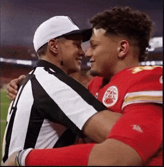 White Hat Man Hugging Red Uniform Player