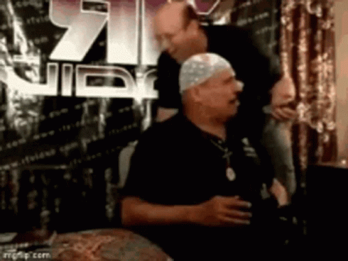 White Hat Man Next To Black Shirt Man GIF