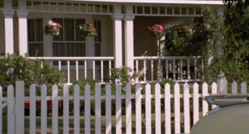 White Picket Fence in Front of White House