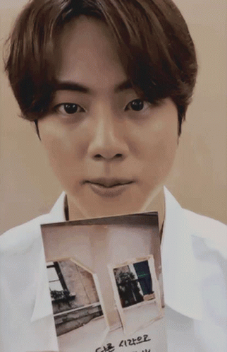 White Shirt Man Holding House Picture With Korean Writing