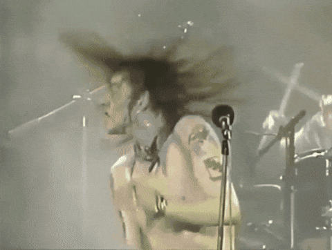 White Shirt Man Singing Into Microphone Arms Outstretched GIF