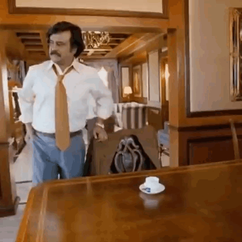 White Shirt Tie Man by Wooden Table With Cup