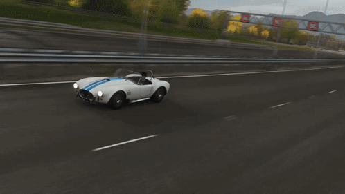 White Sports Car With Blue Strip On Highway GIF