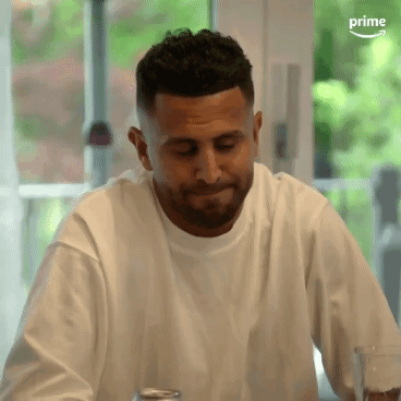 White T-Shirt Man Sitting With Glass of Water