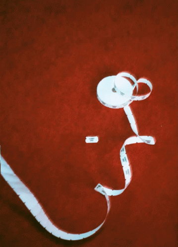 White Tape Measure Labeled A on Red Surface