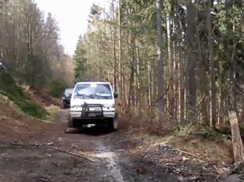 White Truck Driving Down Dirt Road