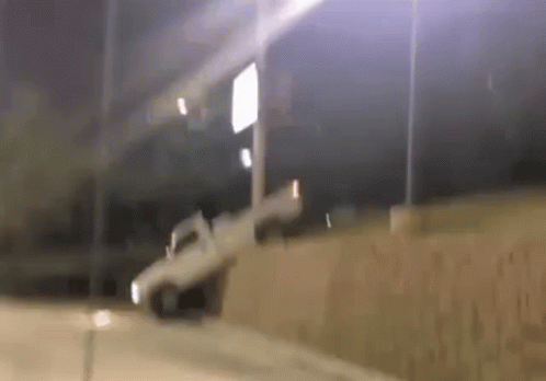 White Truck Driving Down Road at Night