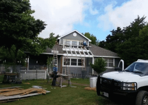 White Truck Parked In Front Of Remodeled House GIF